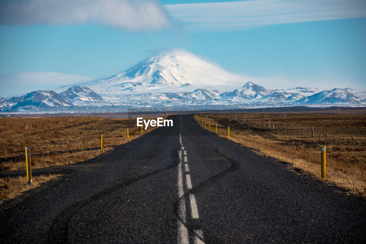 ROAD LEADING TOWARDS SNOWCAPPED MOUNTAINS