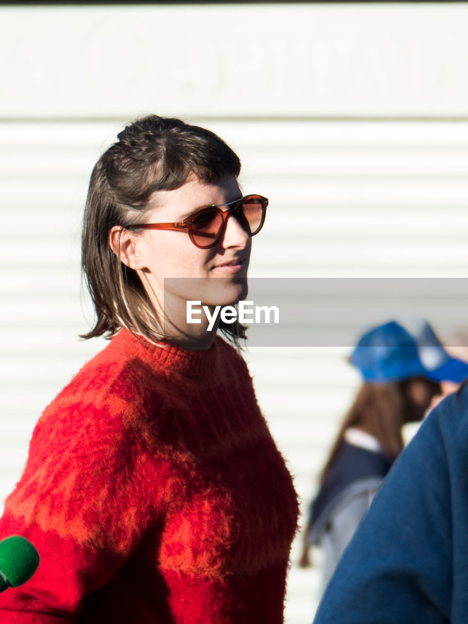 Woman wearing sunglasses and warm clothing outdoors