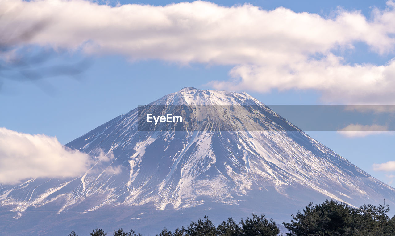 mountain, sky, cloud, snow, volcano, beauty in nature, stratovolcano, scenics - nature, landscape, mountain peak, snowcapped mountain, environment, nature, travel destinations, winter, cold temperature, tree, land, no people, travel, plant, non-urban scene, mountain range, geology, outdoors, tourism, plateau, tranquility, cinder cone, tranquil scene, culture, volcanic landscape, day, blue, forest, physical geography