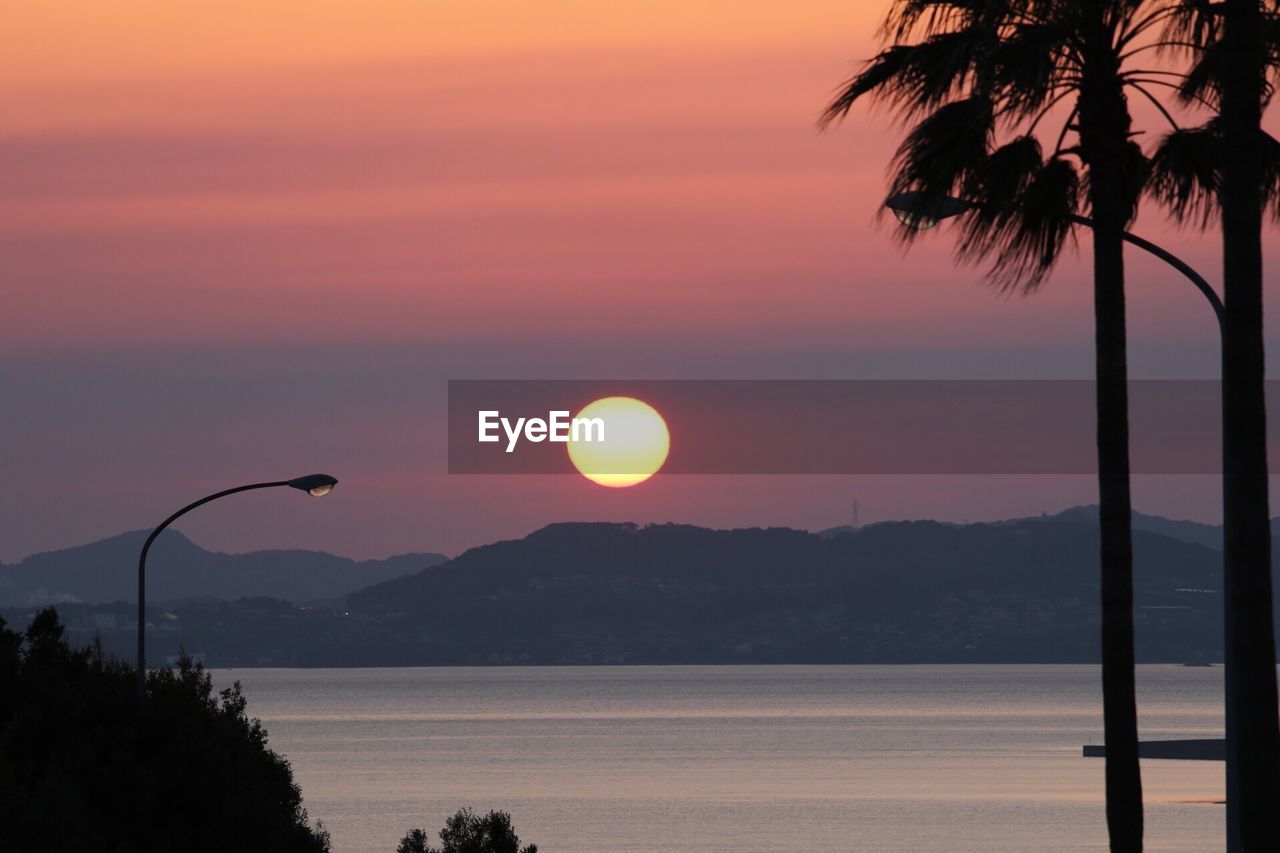 SCENIC VIEW OF SWIMMING POOL AGAINST SKY DURING SUNSET