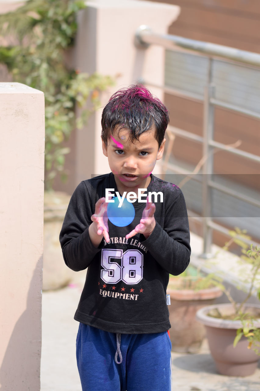 Boy playing with water bomb during holi