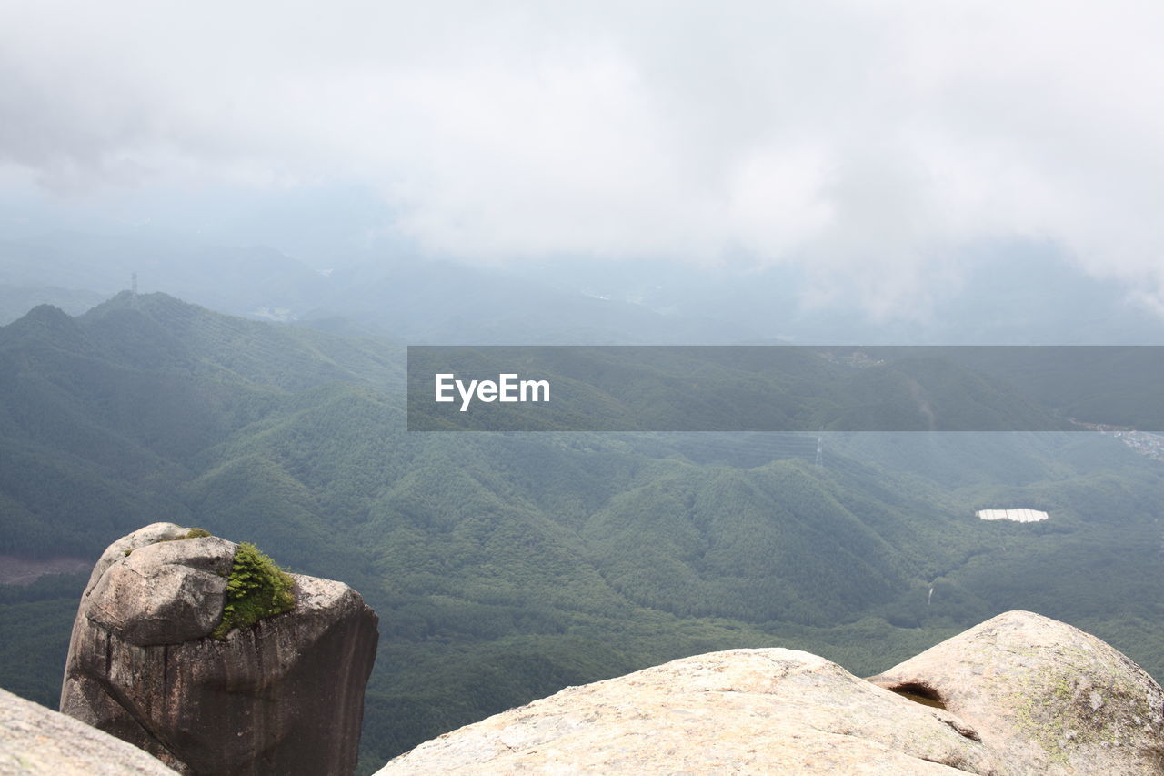 Scenic view of mountains against cloudy sky