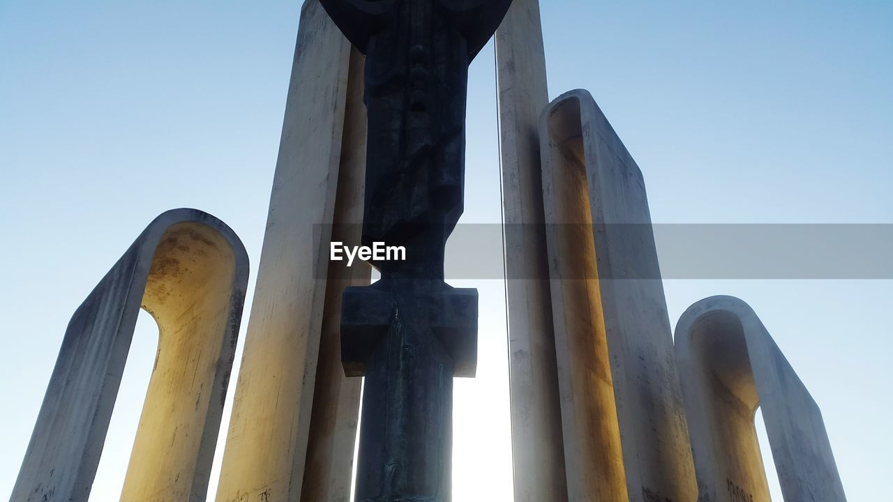 LOW ANGLE VIEW OF MACHINERY AGAINST SKY