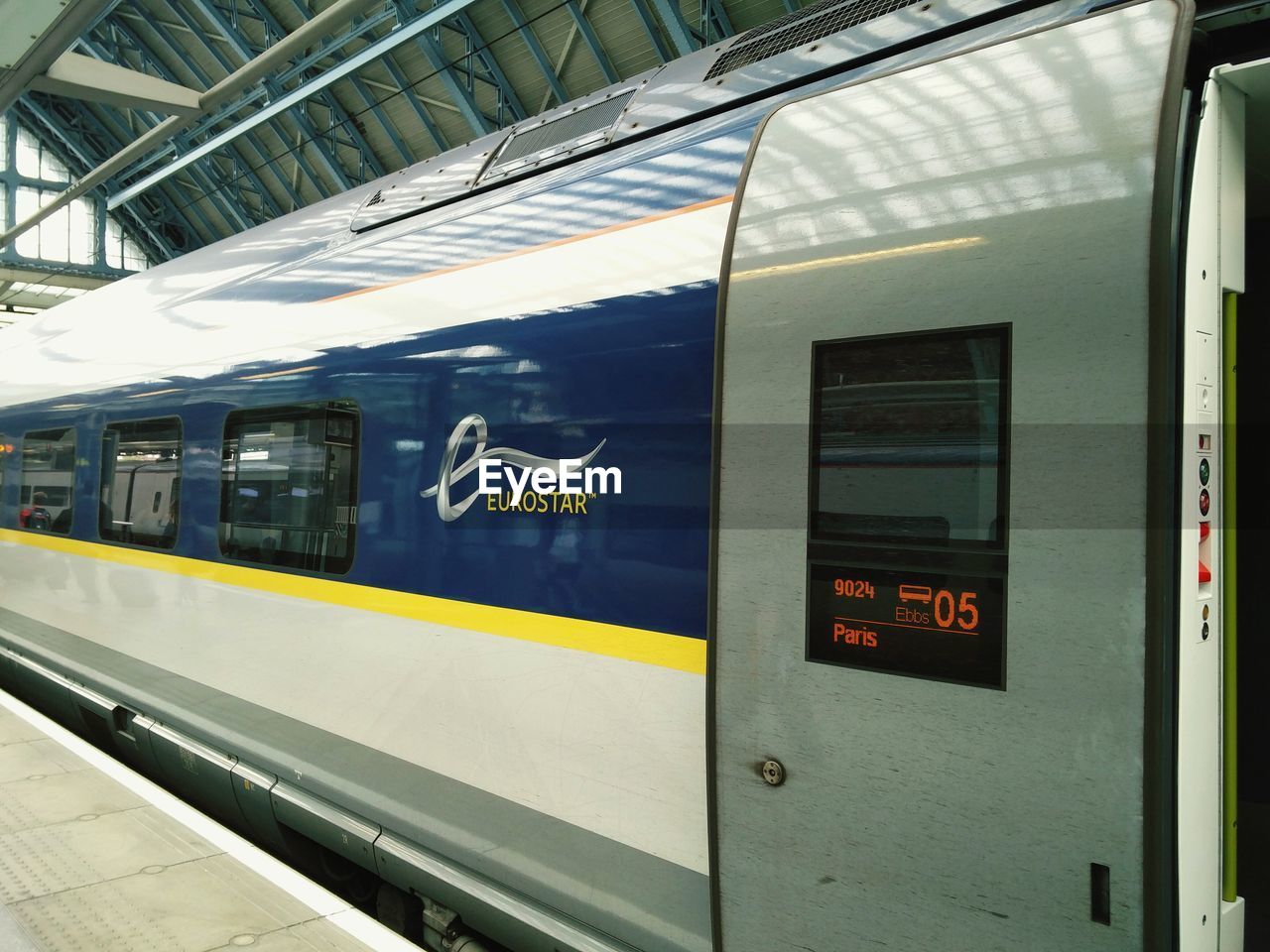 TRAIN ON RAILROAD STATION PLATFORM