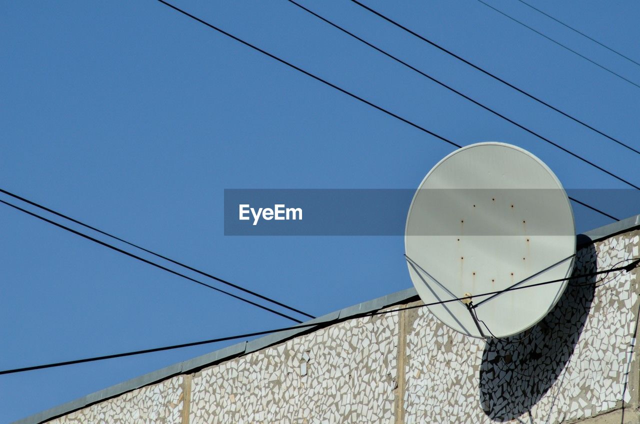 blue, cable, technology, sky, electricity, clear sky, built structure, architecture, no people, line, antenna, low angle view, telecommunications equipment, satellite dish, nature, power supply, white, day, communication, satellite, lighting, building exterior, power line, outdoors, sunny, street light, broadcasting, power generation, wind, wire, television antenna