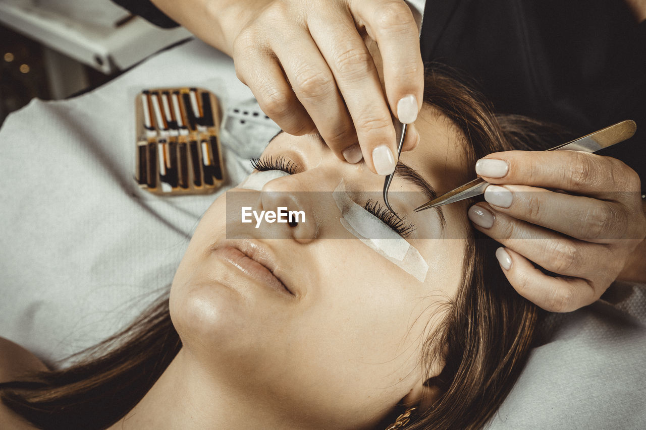 Beautician working with mask and protective screen for the virus covid