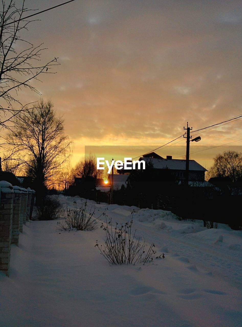 Scenic view of snow covered landscape at sunset