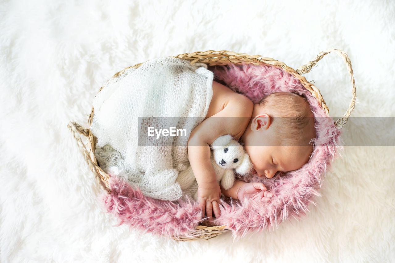 portrait of cute baby girl lying on bed