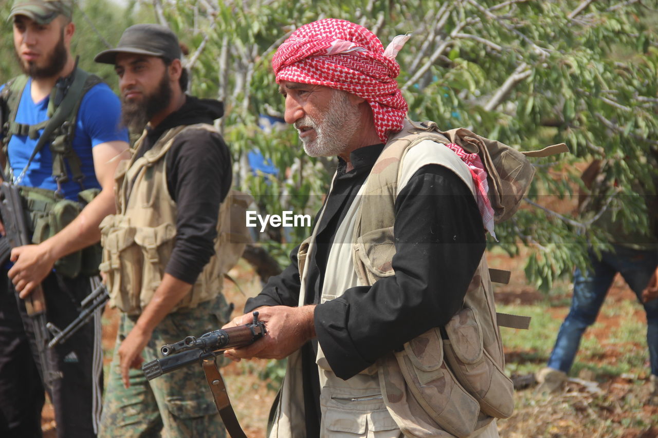 Aleppo, syria 19 february 2017 an old man holds a weapon to defend his land against isis