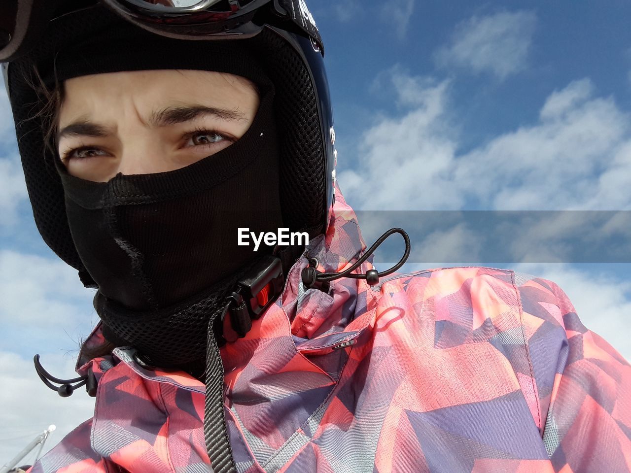 Low angle view of person wearing skiing helmet against sky