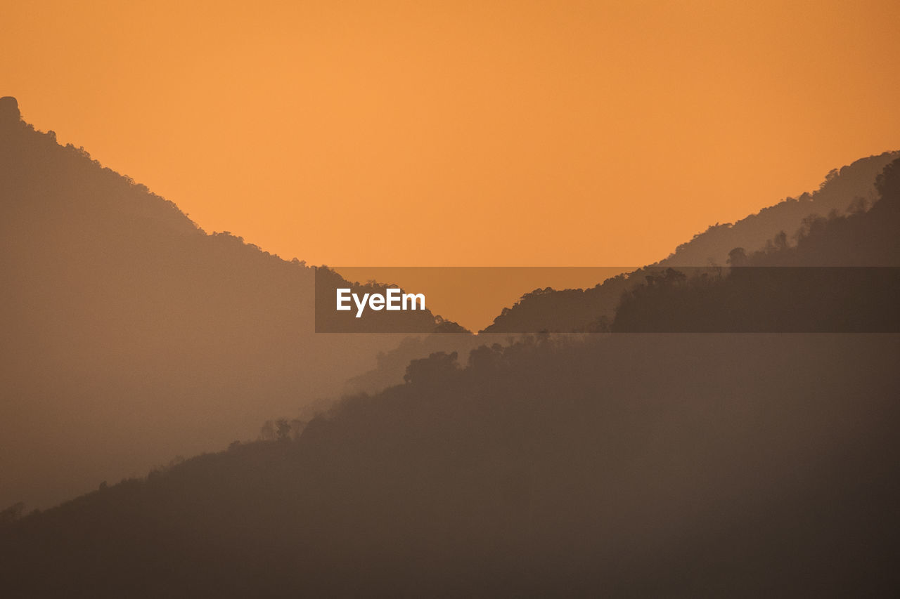 SCENIC VIEW OF MOUNTAINS DURING SUNSET