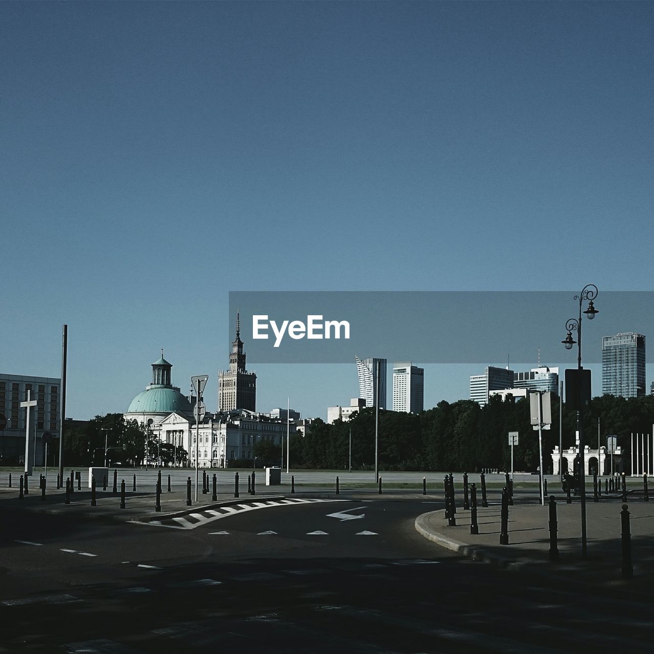 EMPTY ROAD WITH BUILDINGS IN BACKGROUND