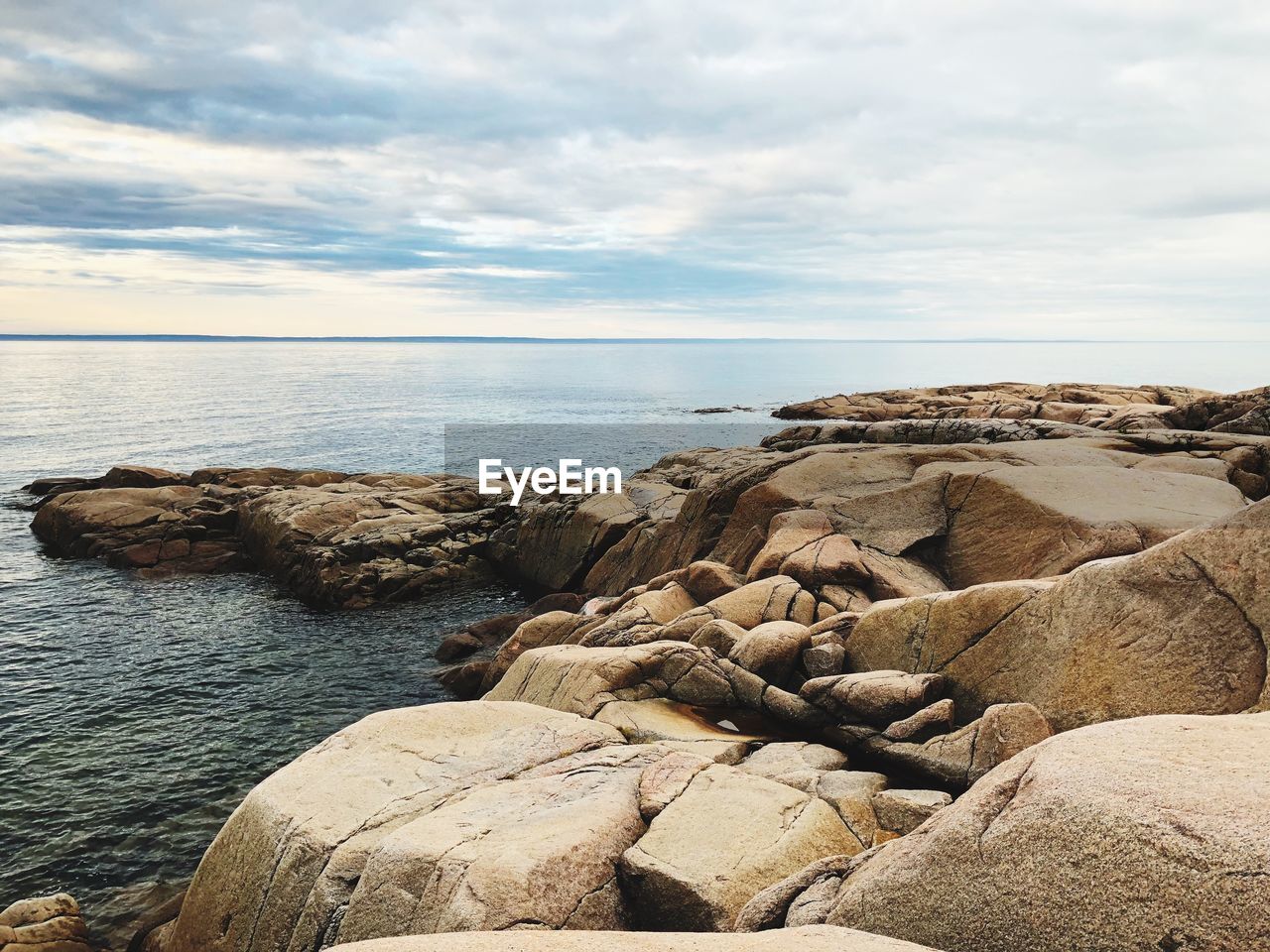 Rocks on beach against sky