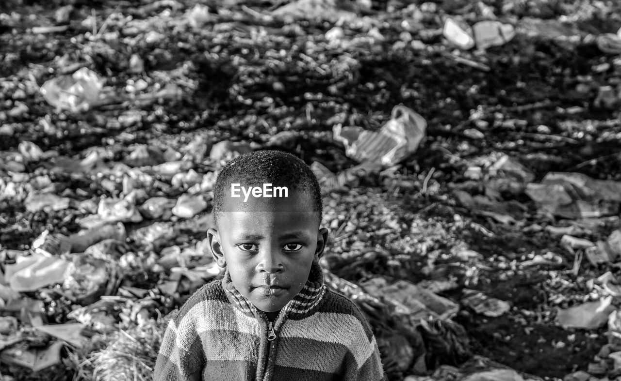 Portrait of boy against garbage