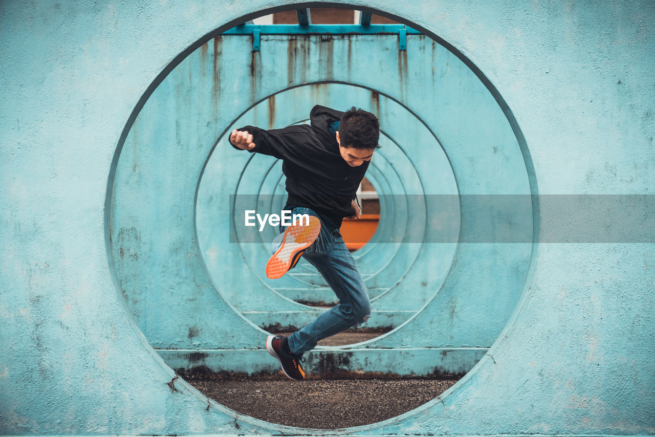 Man jumping through blue circles