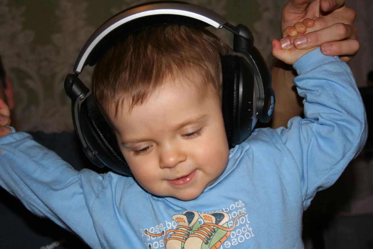 CLOSE-UP OF SMILING BOY WITH BABY IN NIGHTCLUB