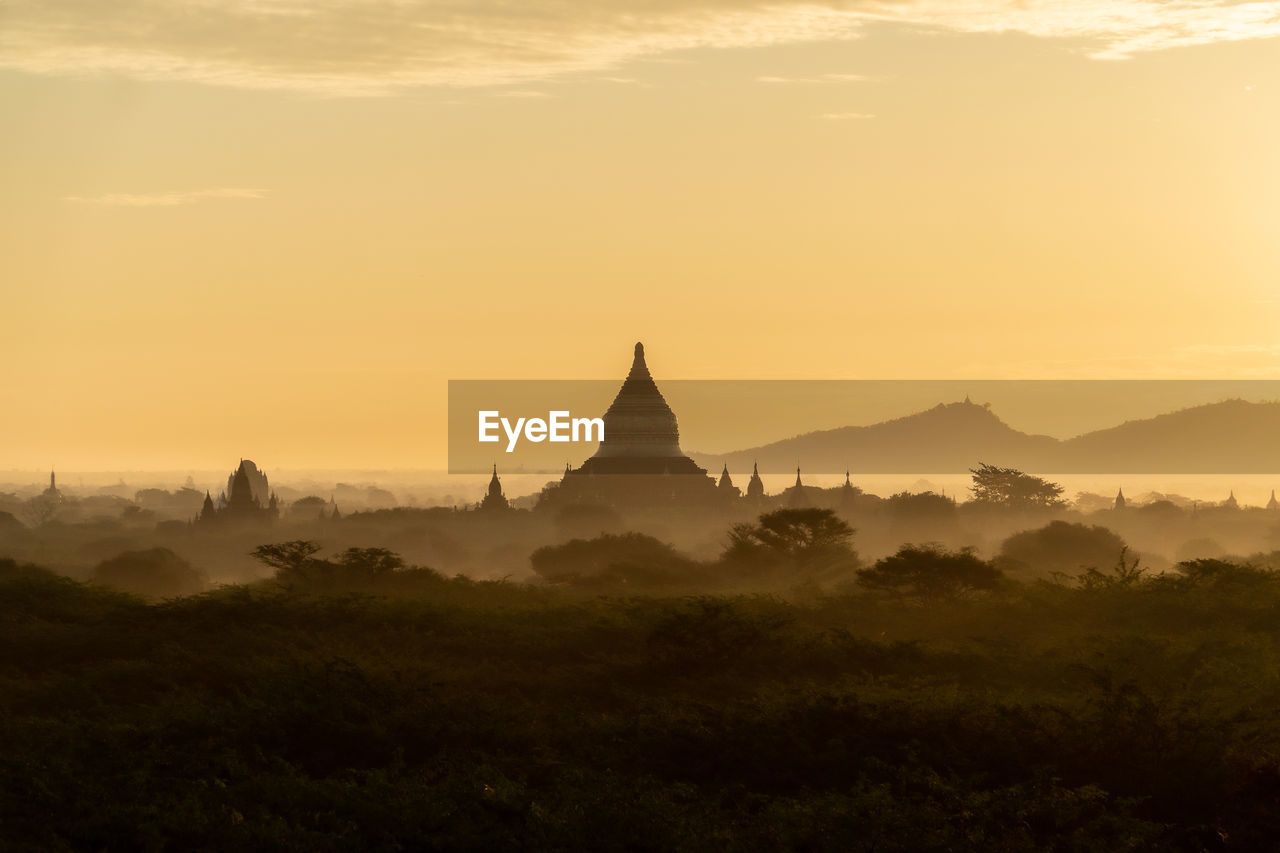 View of pagoda against sky during sunrise