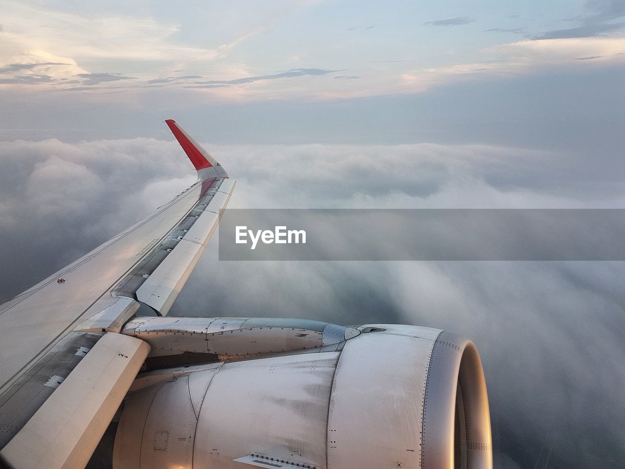 AIRPLANE WING OVER CLOUDSCAPE