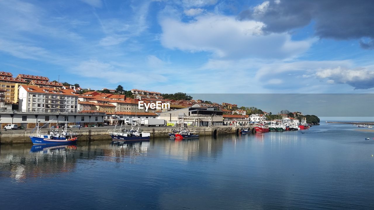 Boats moored at harbor