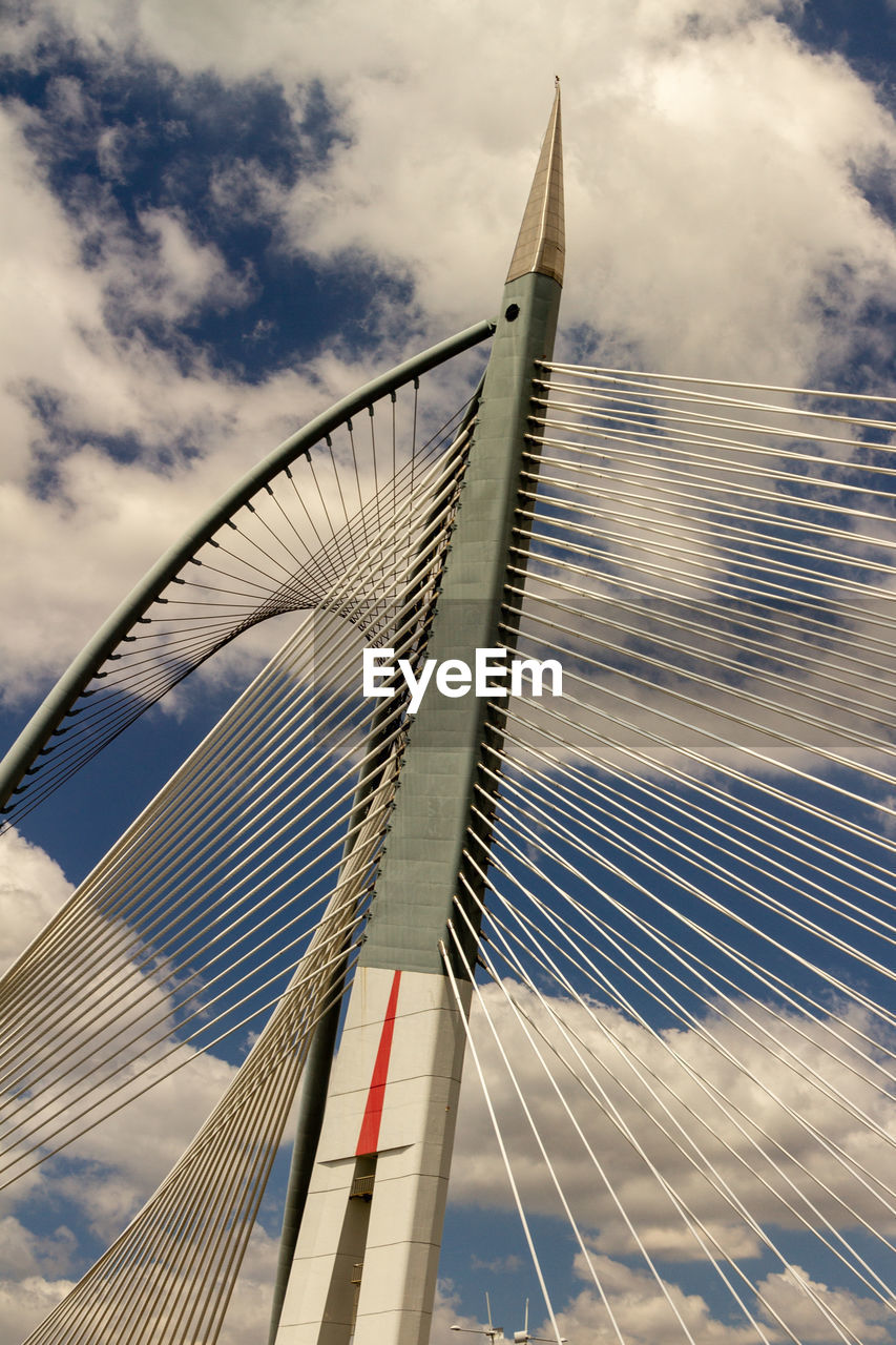 LOW ANGLE VIEW OF BRIDGE AGAINST CLOUDY SKY