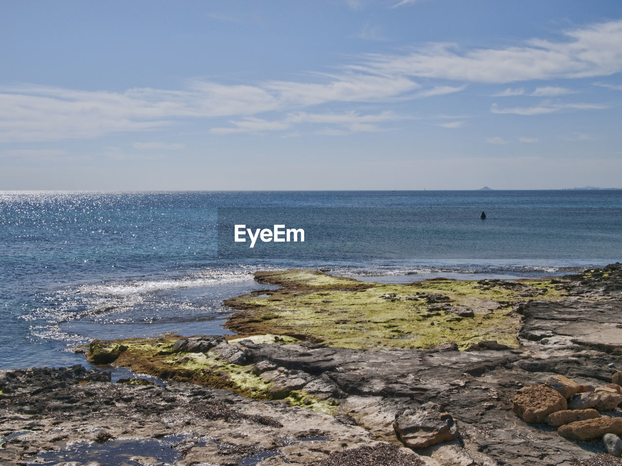 SCENIC VIEW OF ROCKS ON BEACH AGAINST SKY