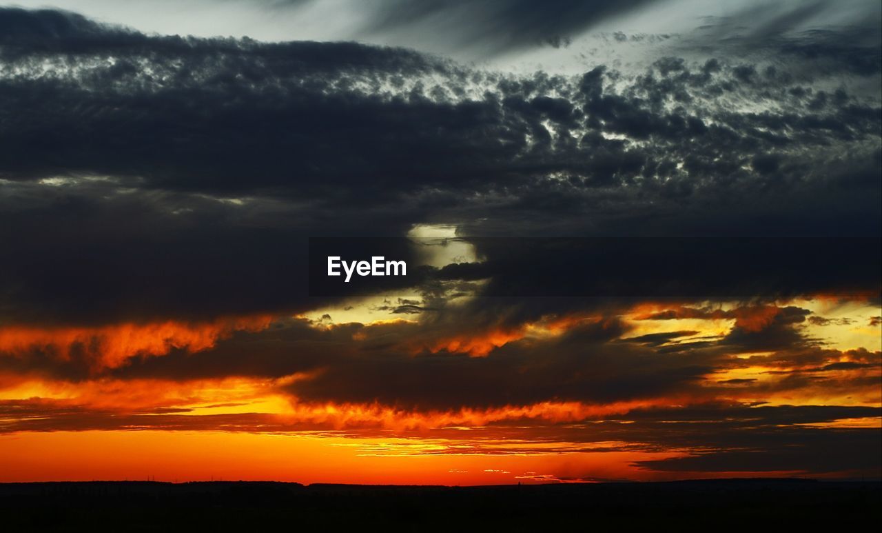 SCENIC VIEW OF DRAMATIC SKY OVER SILHOUETTE LANDSCAPE