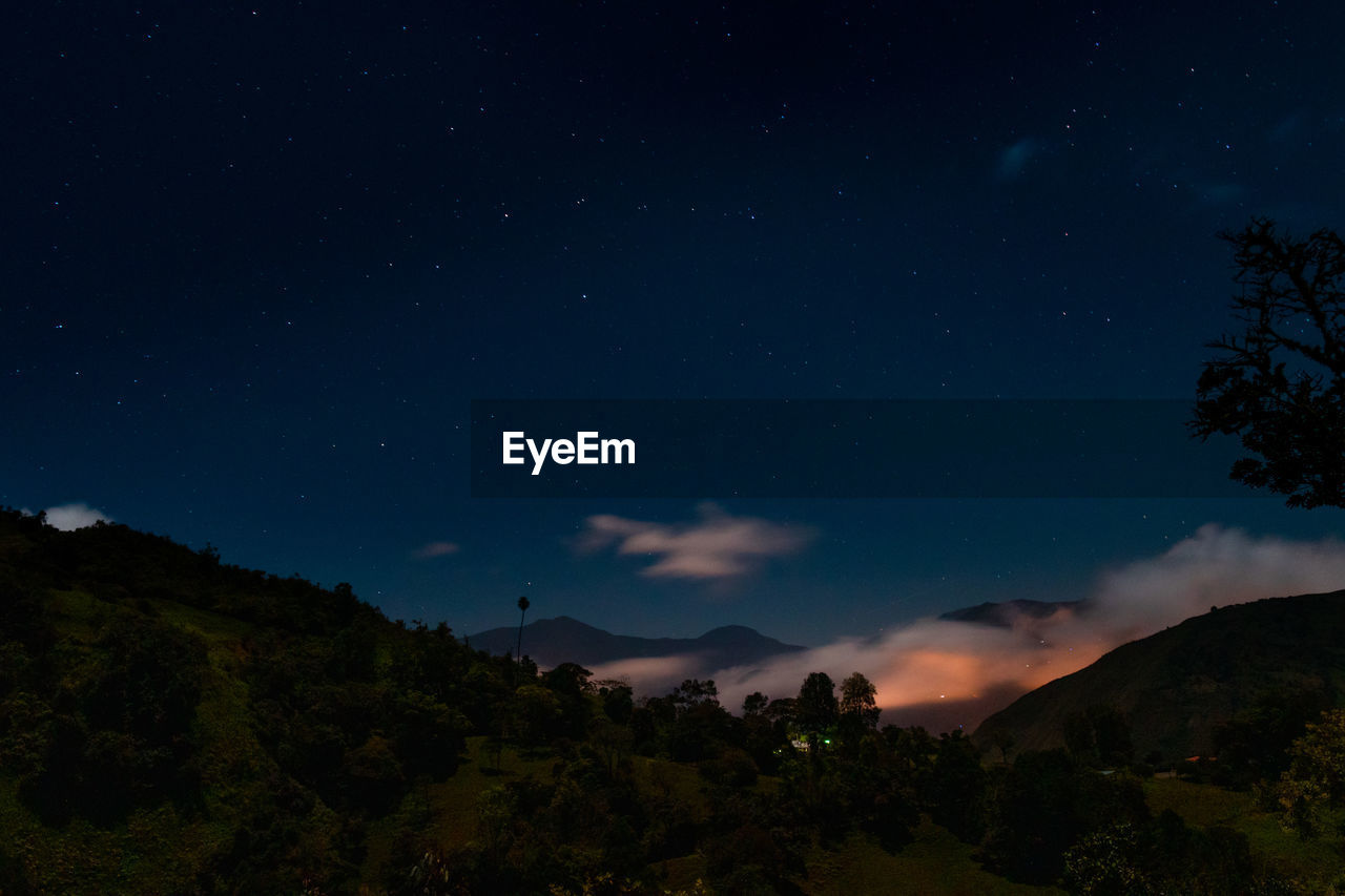 High angle view of trees against sky at night