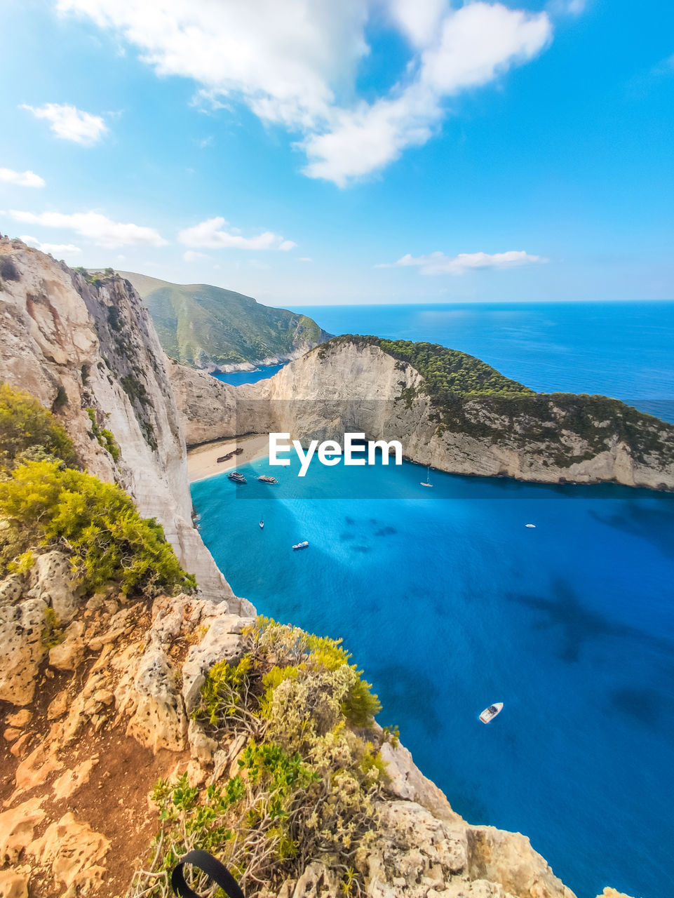 Scenic view of sea and mountains against sky