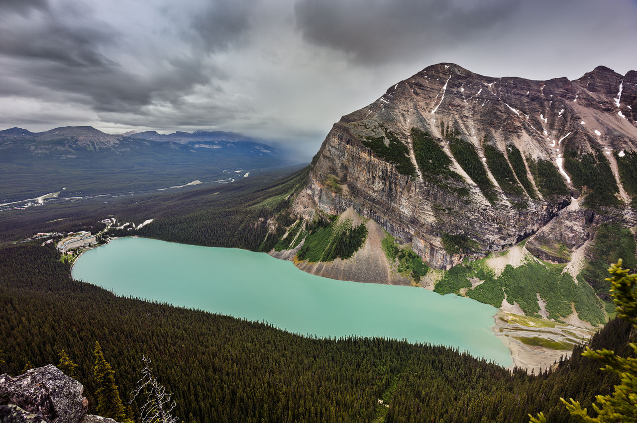 Scenic view of mountains against cloudy sky