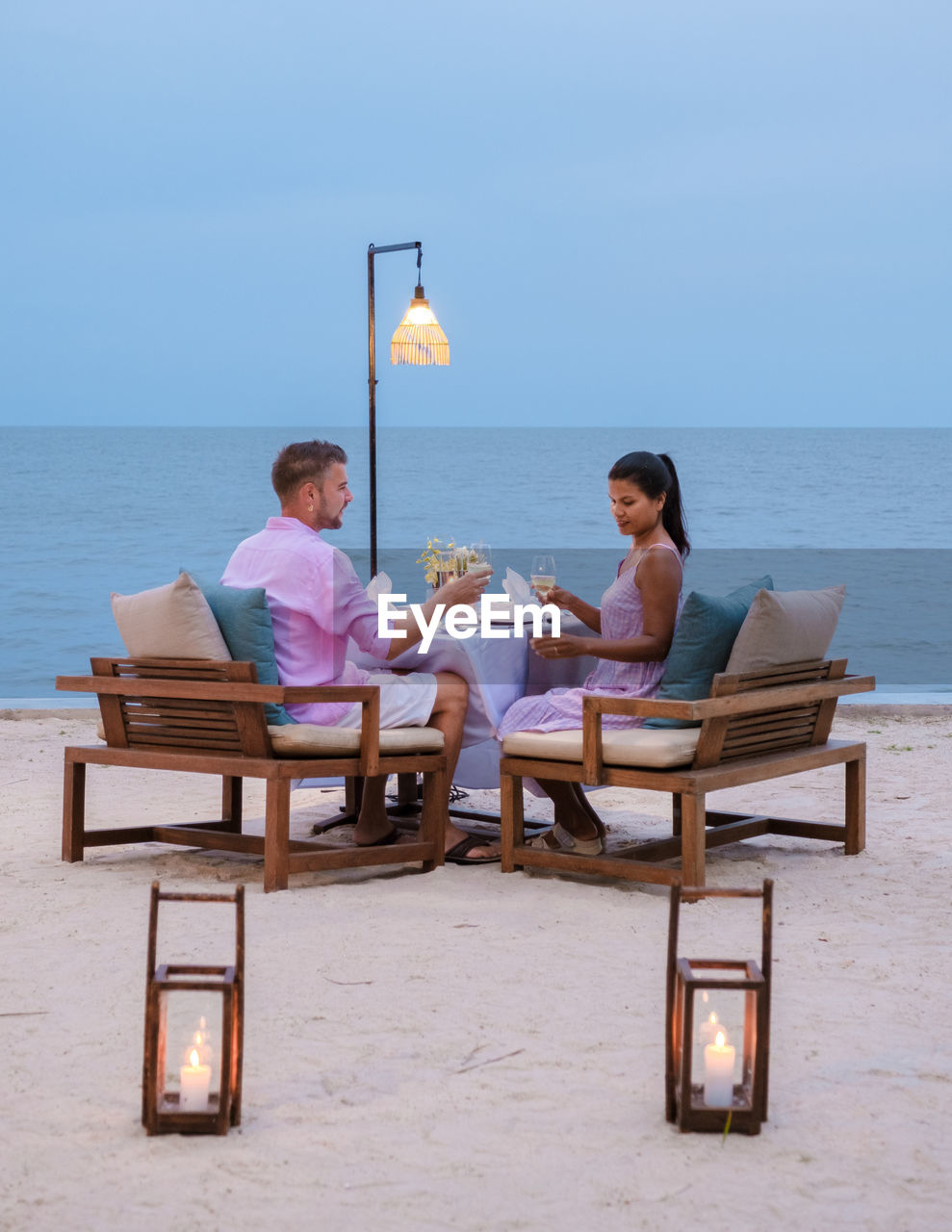 rear view of woman sitting at beach