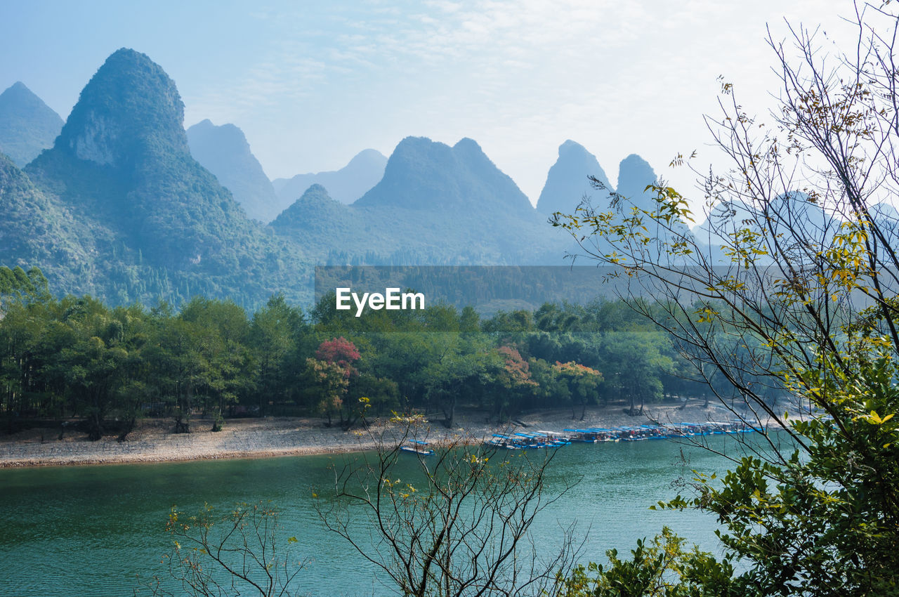 Scenic view of lake and mountains against sky