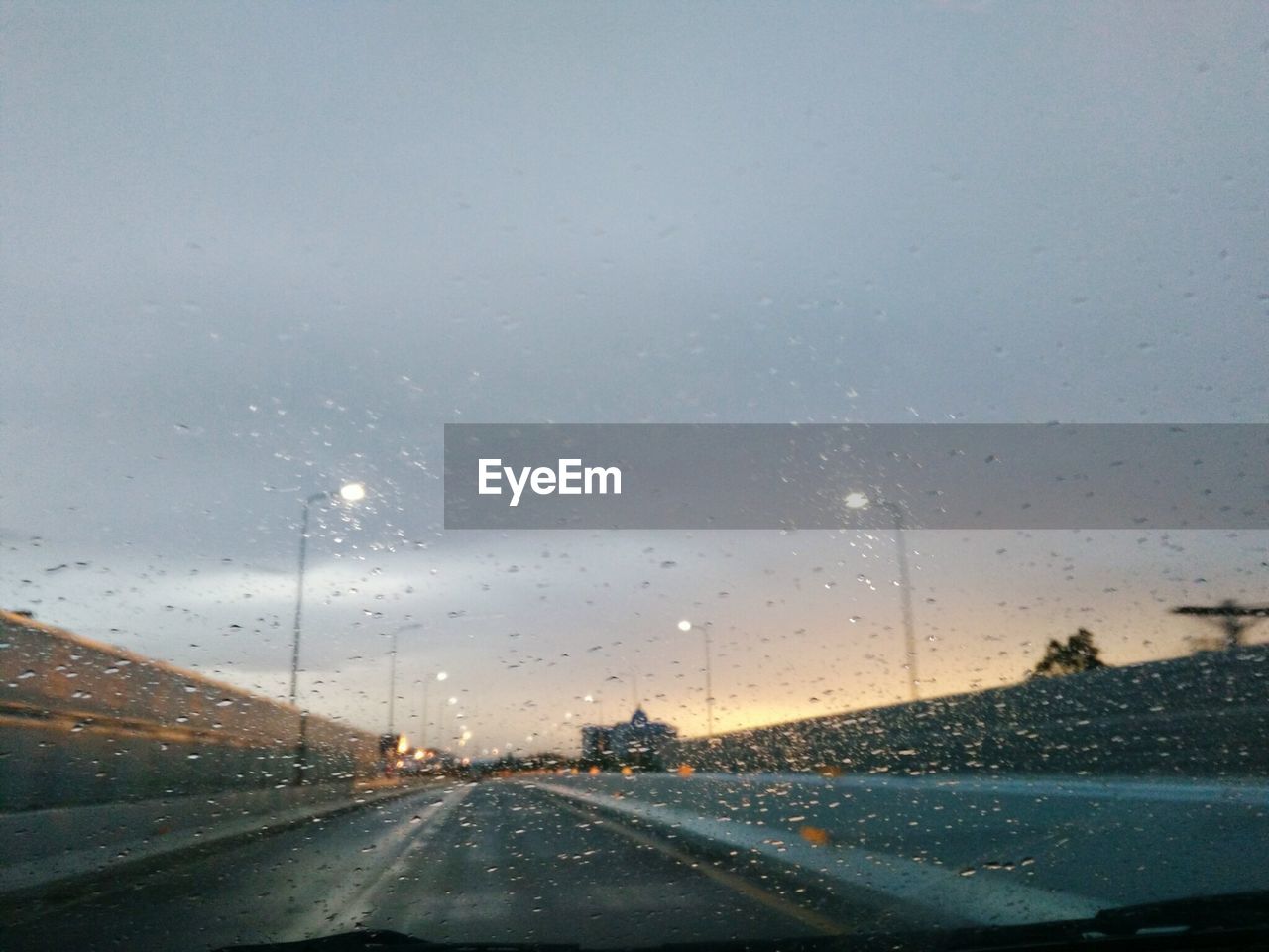 ROAD SEEN THROUGH CAR WINDSHIELD