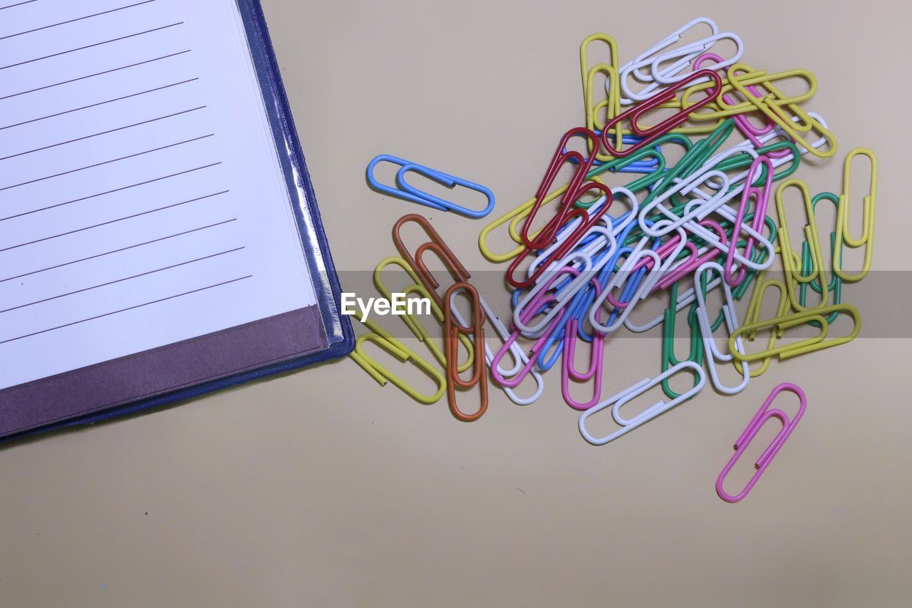 Directly above shot of paper and clips on table