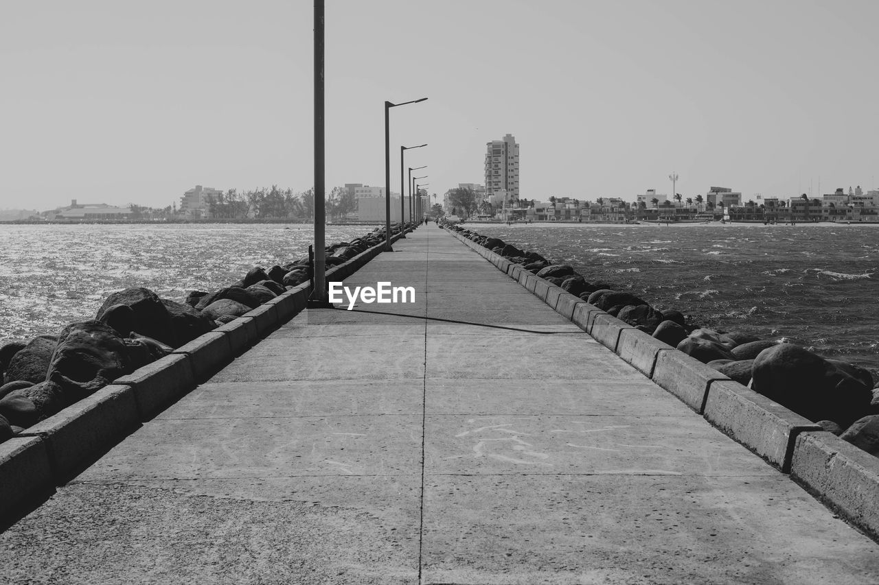 BRIDGE OVER CITY AGAINST SKY