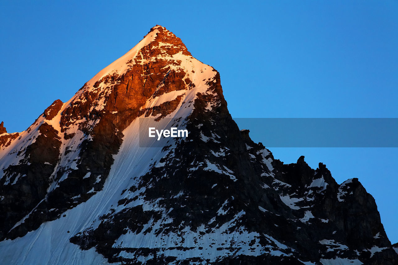 Low angle view of snowcapped mountain at gran paradiso national park