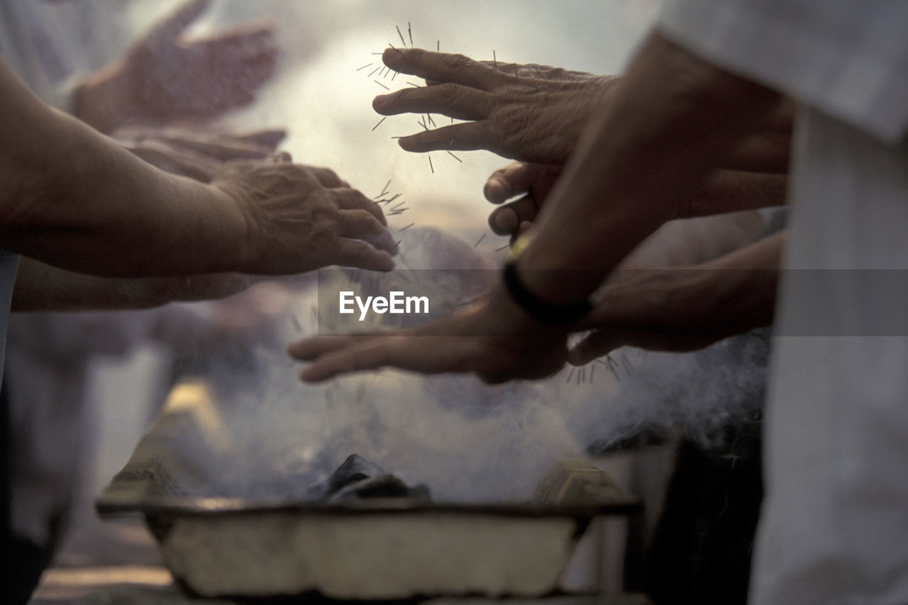 Cropped image of people getting acupuncture treatment