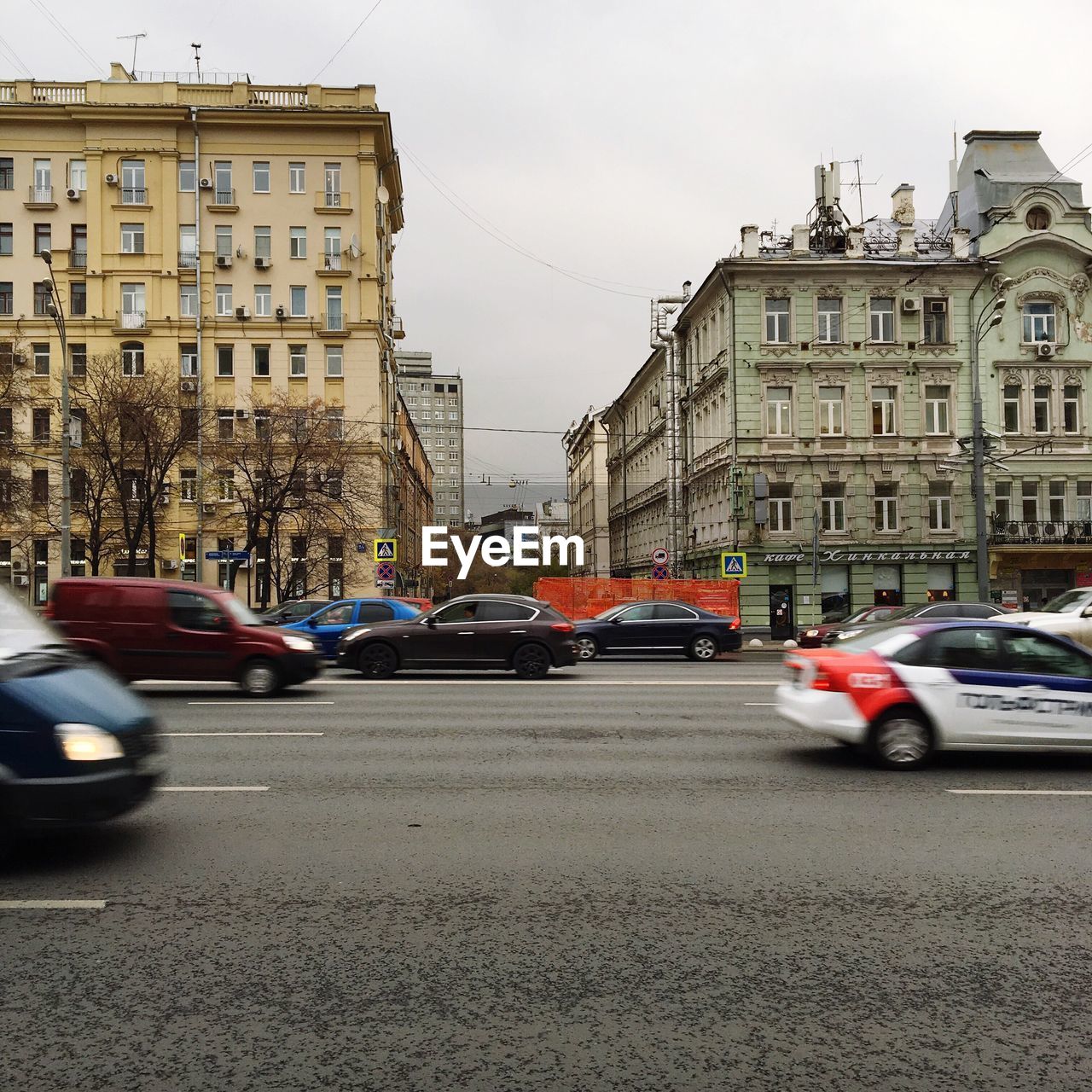 Cars on road against sky in city