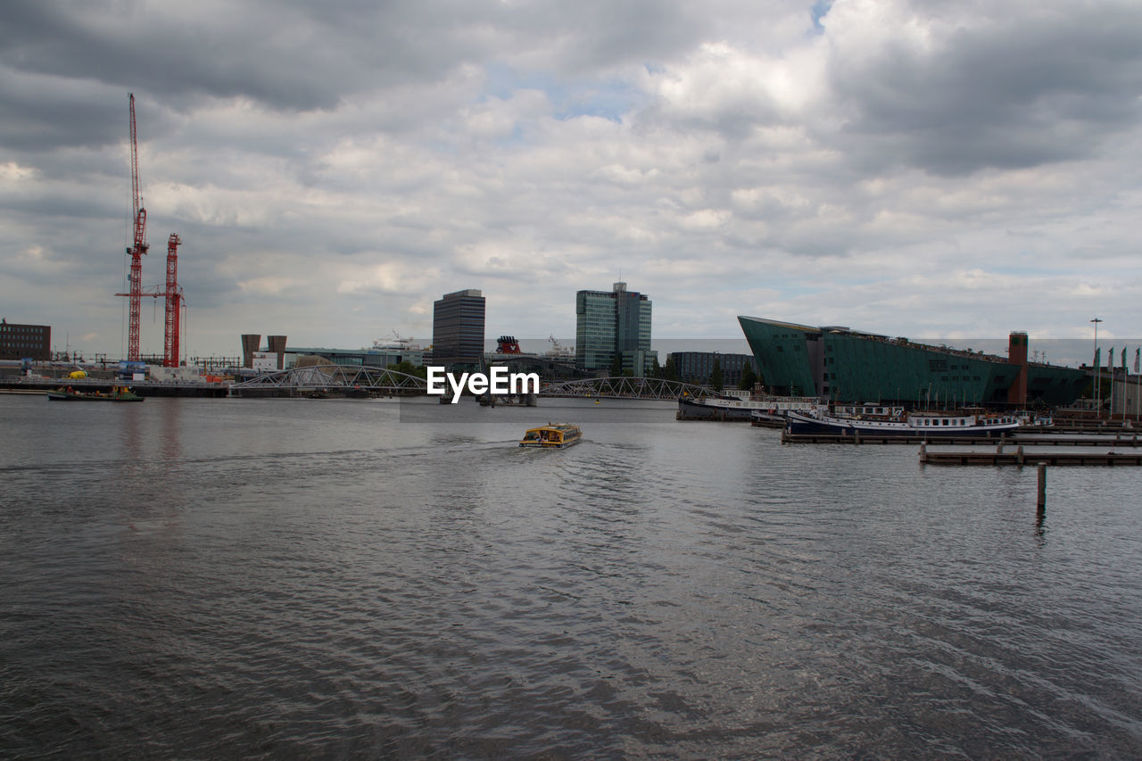 CITY BY RIVER AGAINST SKY