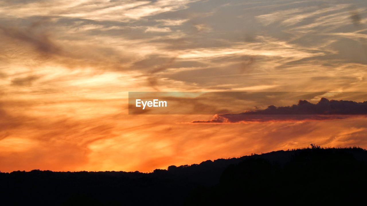 Scenic view of dramatic sky during sunset