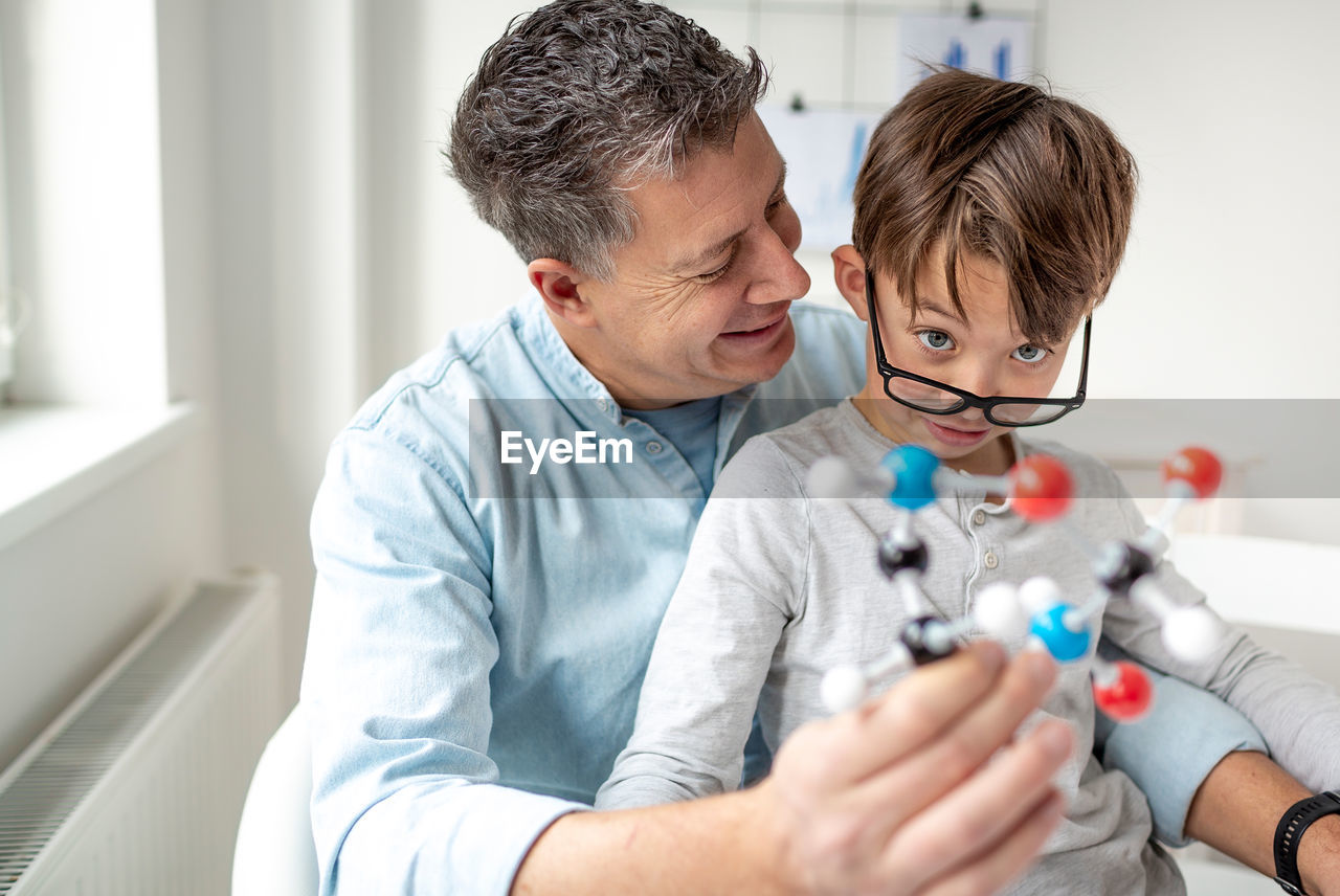 Father and son with toy at home