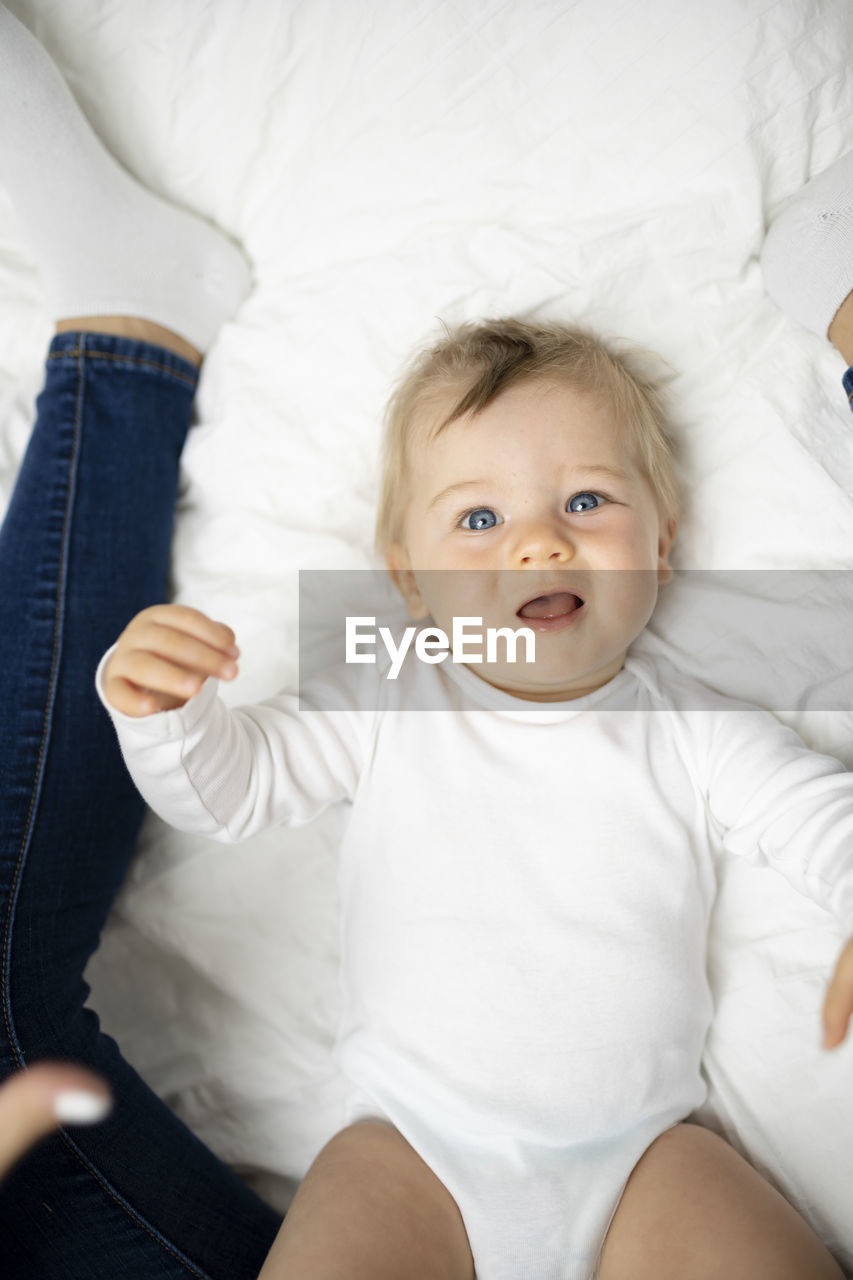 portrait of cute baby boy sleeping on bed