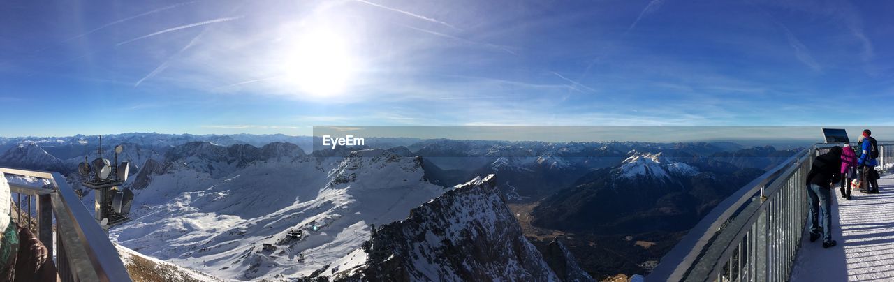 Panoramic view of snowcapped mountains against bright sky