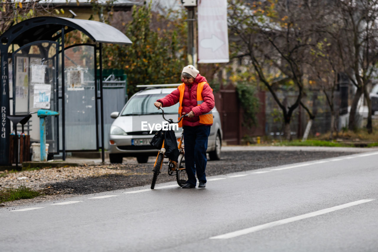 MAN RIDING BICYCLE ON ROAD