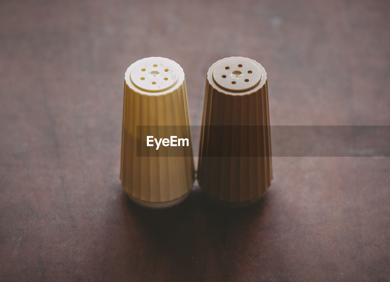 Close-up of salt and pepper shakers on table