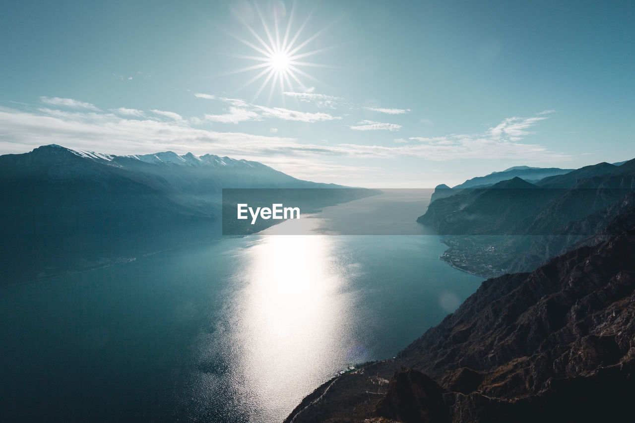 Scenic view of sea and mountains against sky