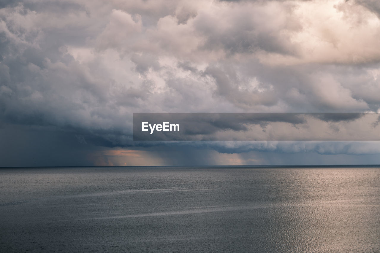 Scenic view of sea against stormy sky