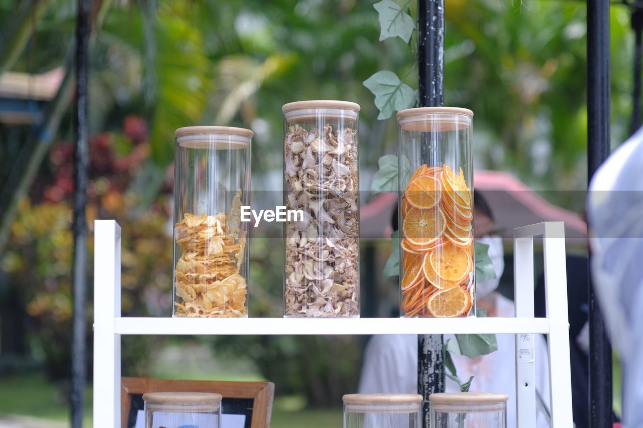 food and drink, food, container, jar, nature, plant, day, freshness, outdoors, glass, no people, focus on foreground, retail, variation, bird feeder, healthy eating, table, drink, summer, refreshment, wellbeing, fruit