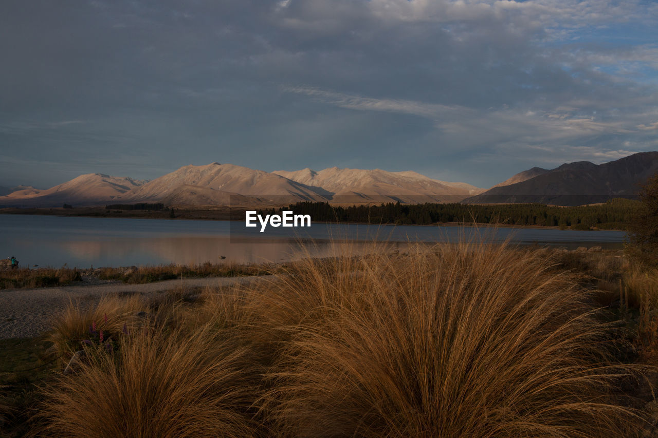Scenic view of lake tekapo  and mountains against sky