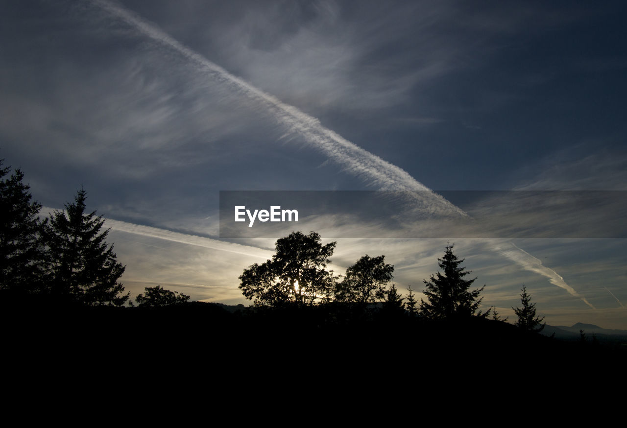 LOW ANGLE VIEW OF VAPOR TRAILS IN SKY