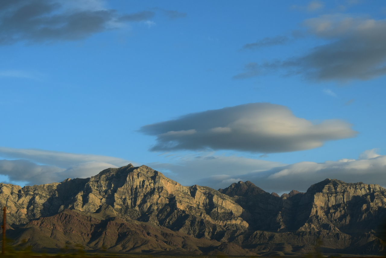 SCENIC VIEW OF MOUNTAINS AGAINST CLOUDY SKY